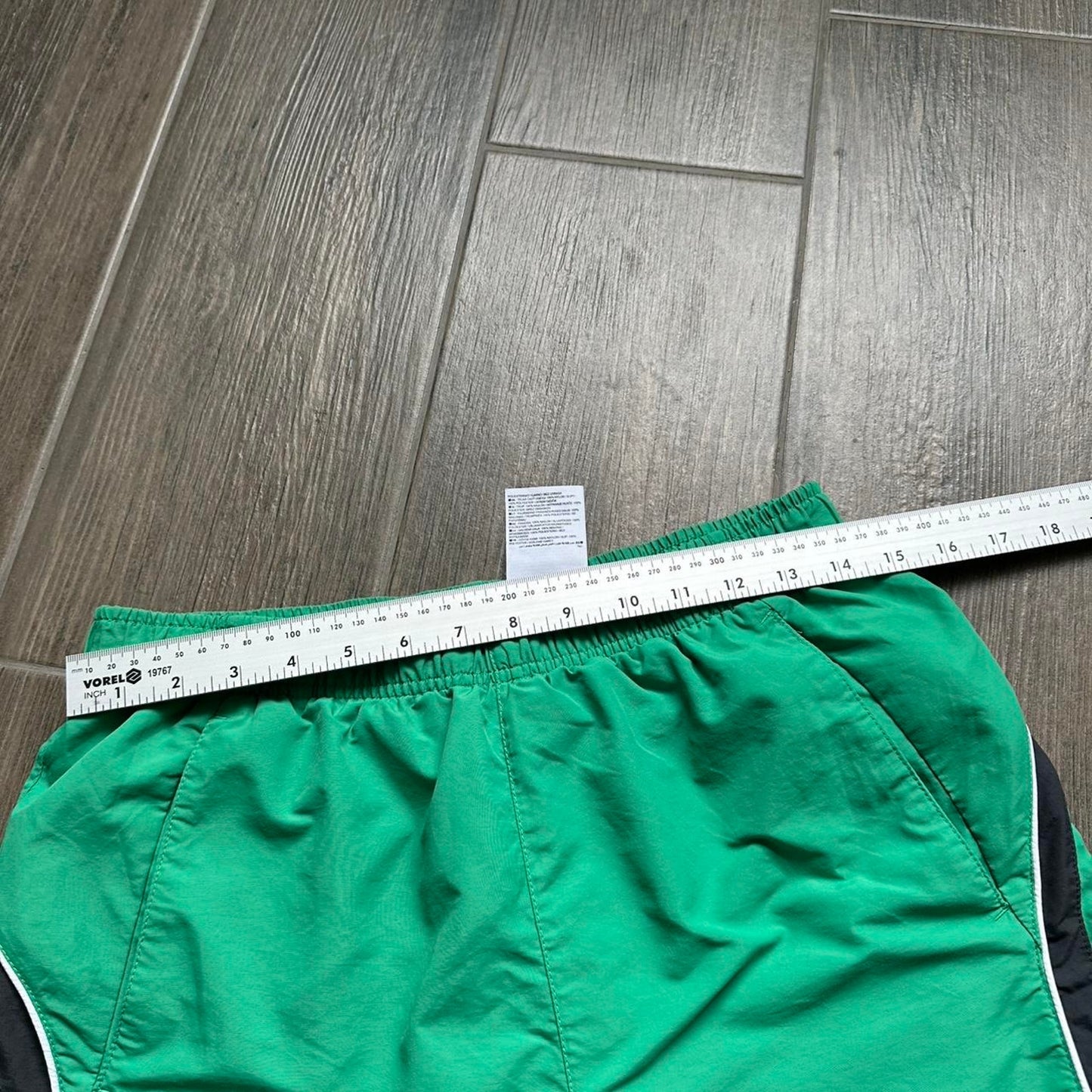 Nike green shorts with white and black stripes