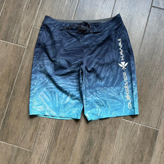 Quiksilver blue board shorts with palm tree design