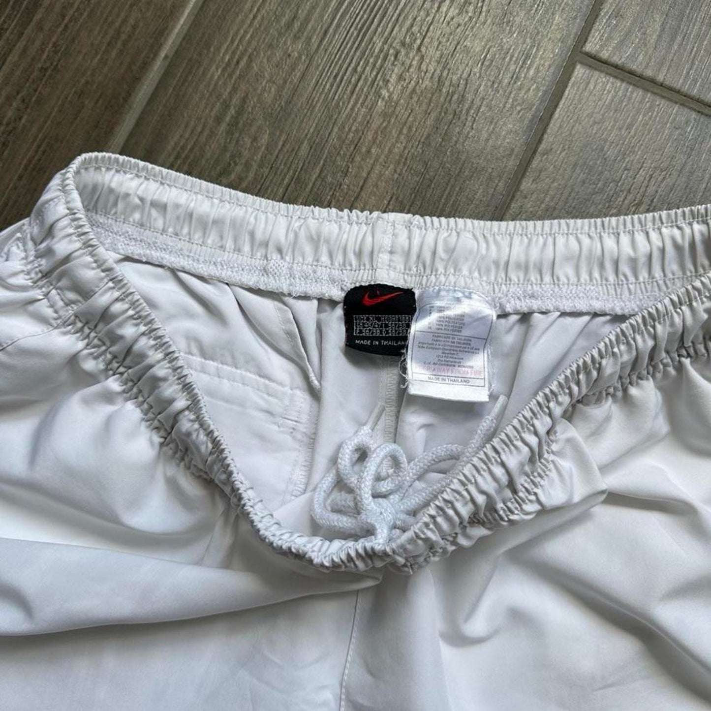 Nike white shorts with black swoosh