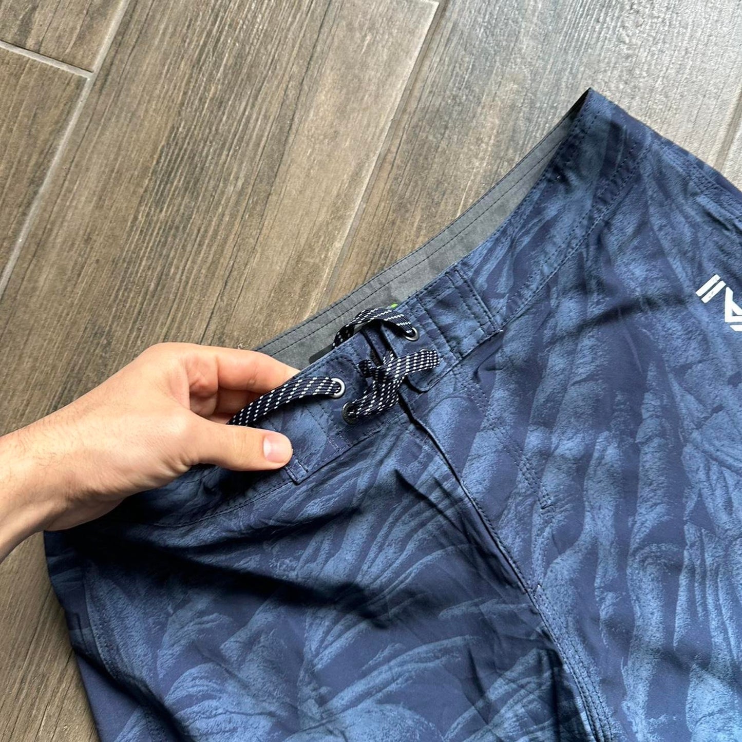 Quiksilver blue board shorts with palm tree design