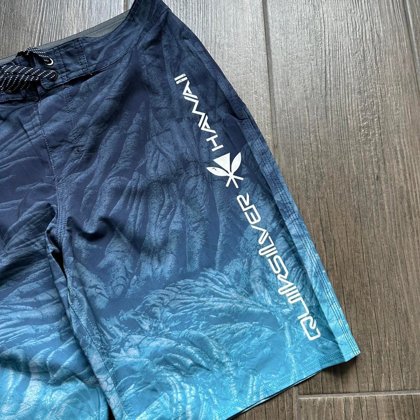 Quiksilver blue board shorts with palm tree design