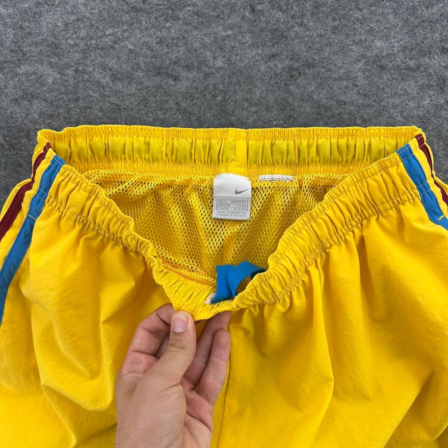Nike yellow track shorts