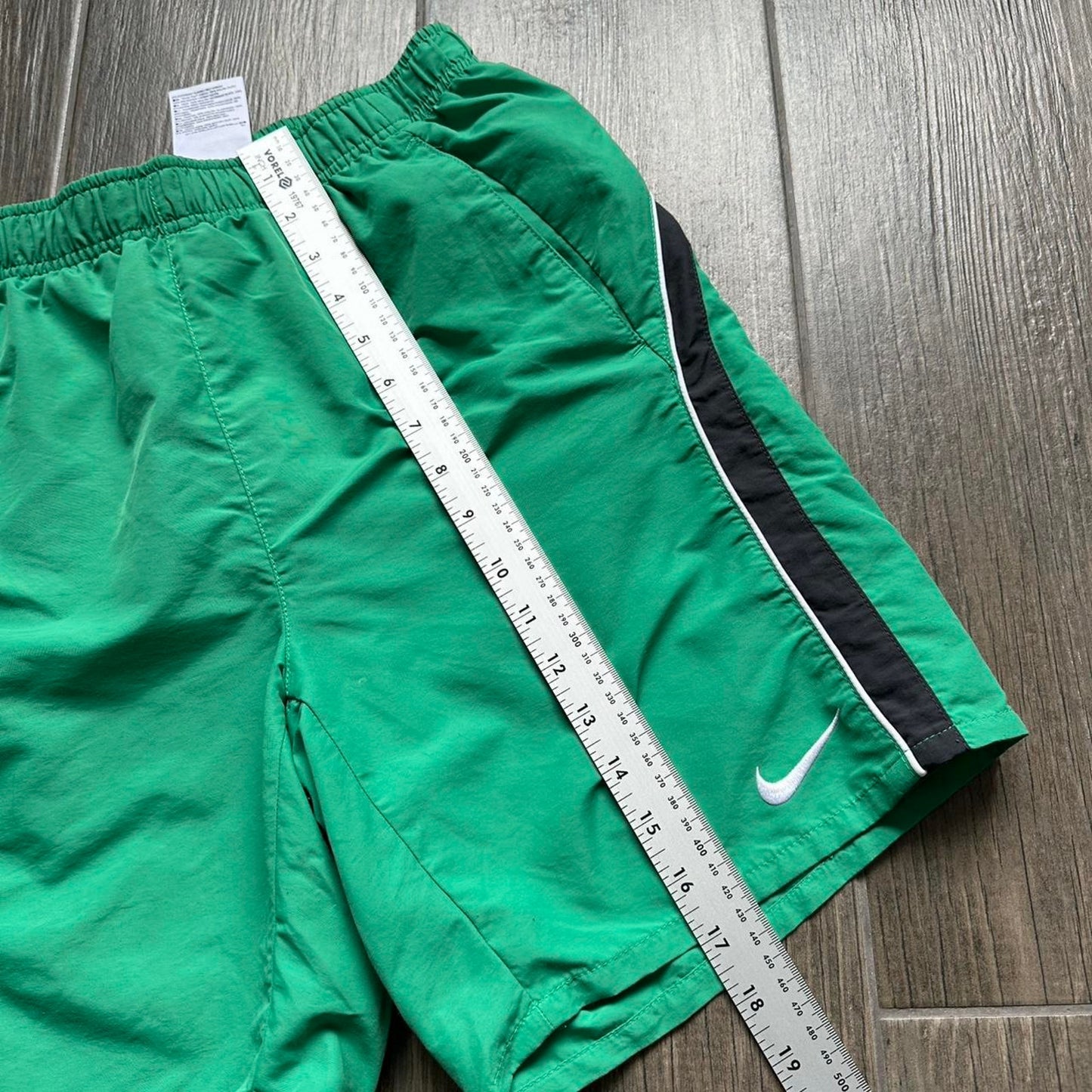 Nike green shorts with white and black stripes