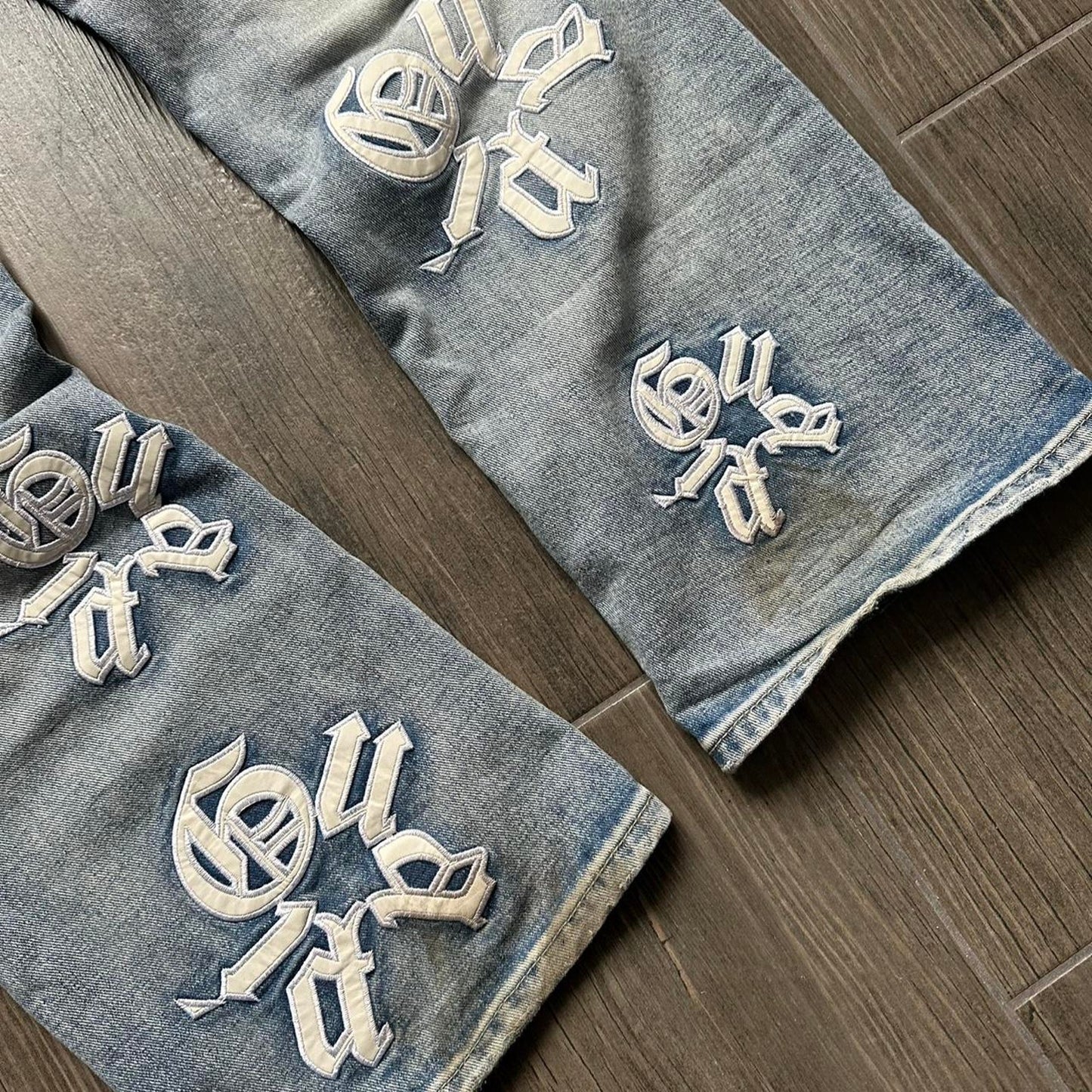 Distressed blue denim jeans with