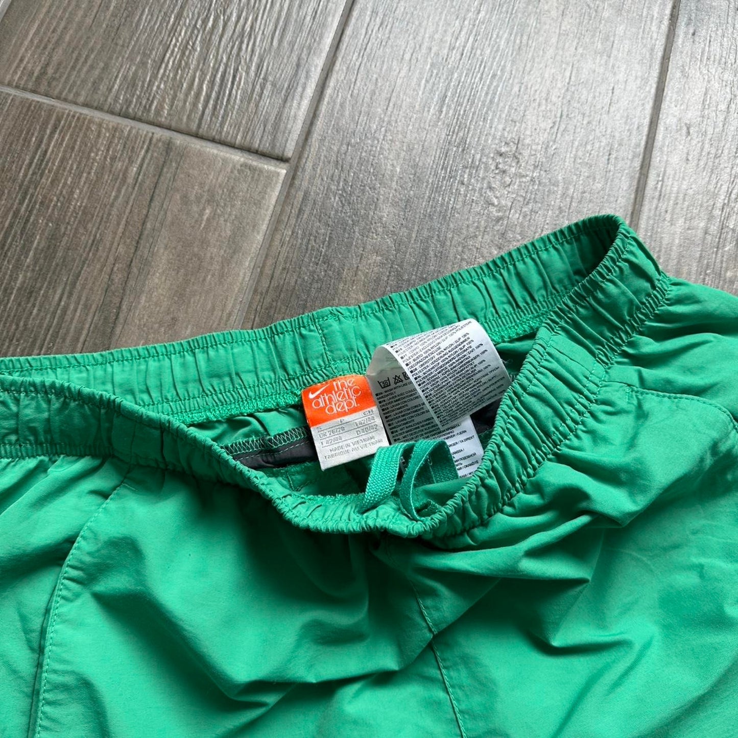 Nike green shorts with white and black stripes