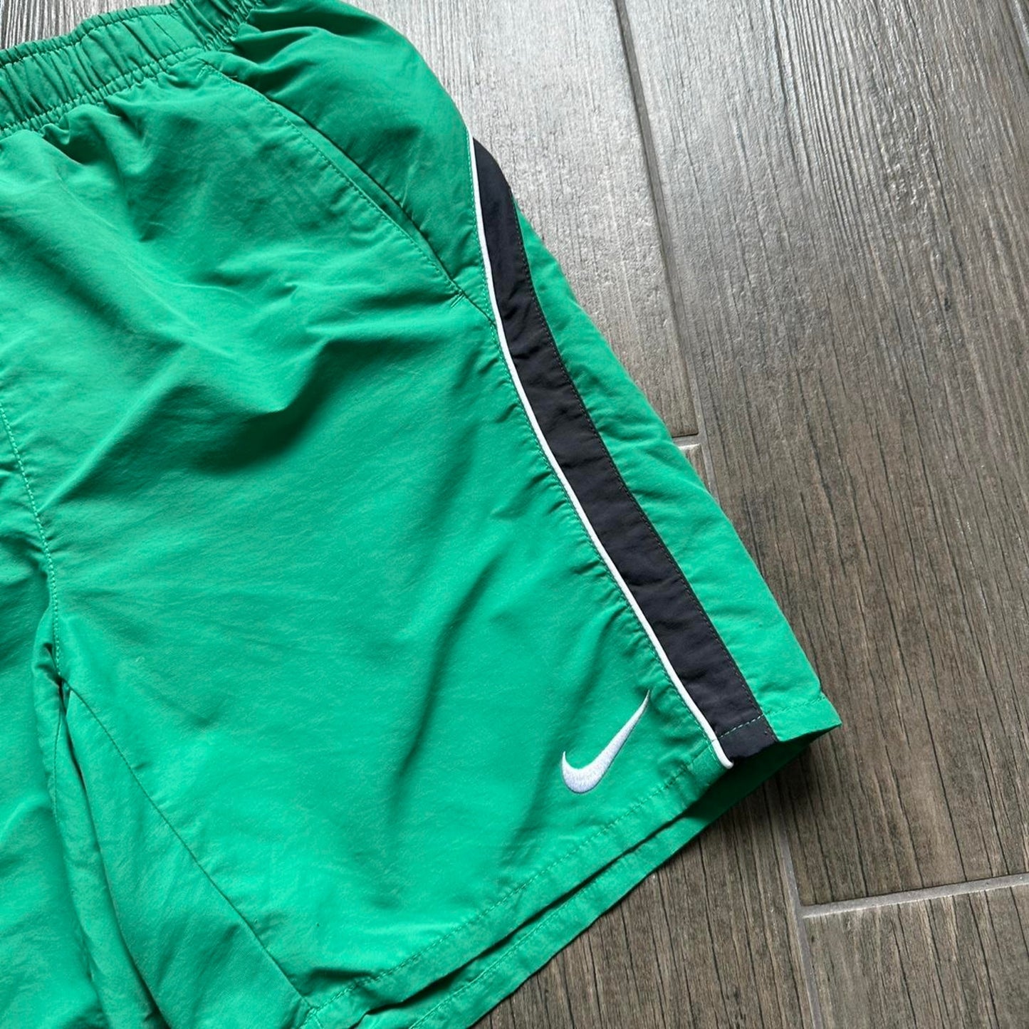 Nike green shorts with white and black stripes