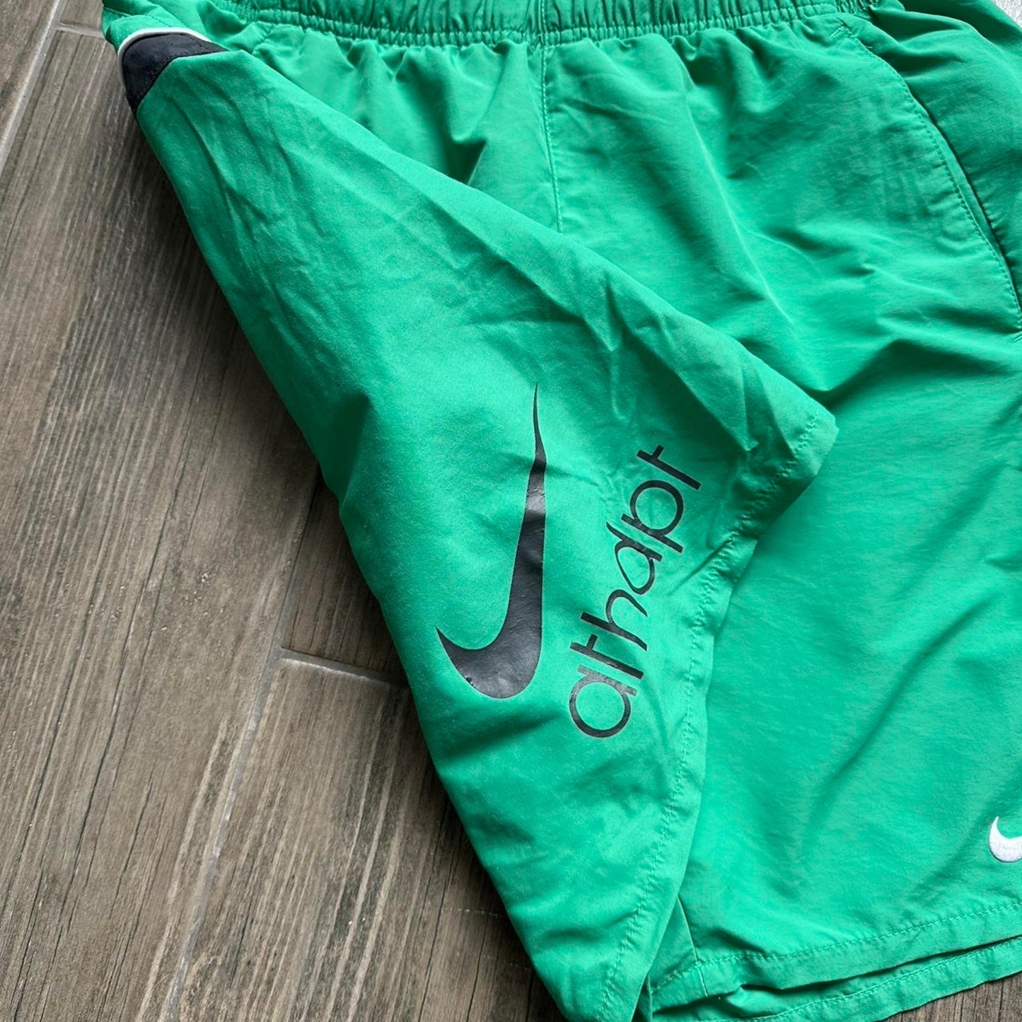 Nike green shorts with white and black stripes