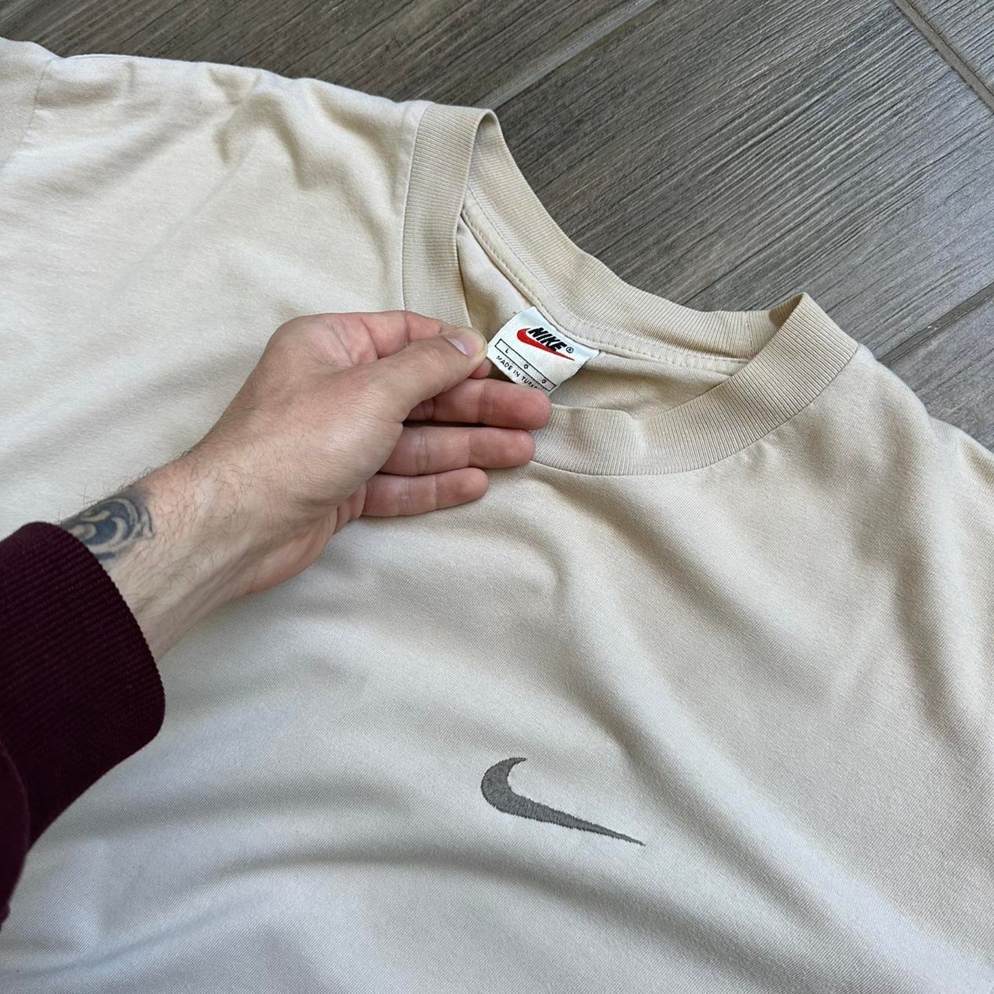 Cream Nike tee with embroidered swoosh