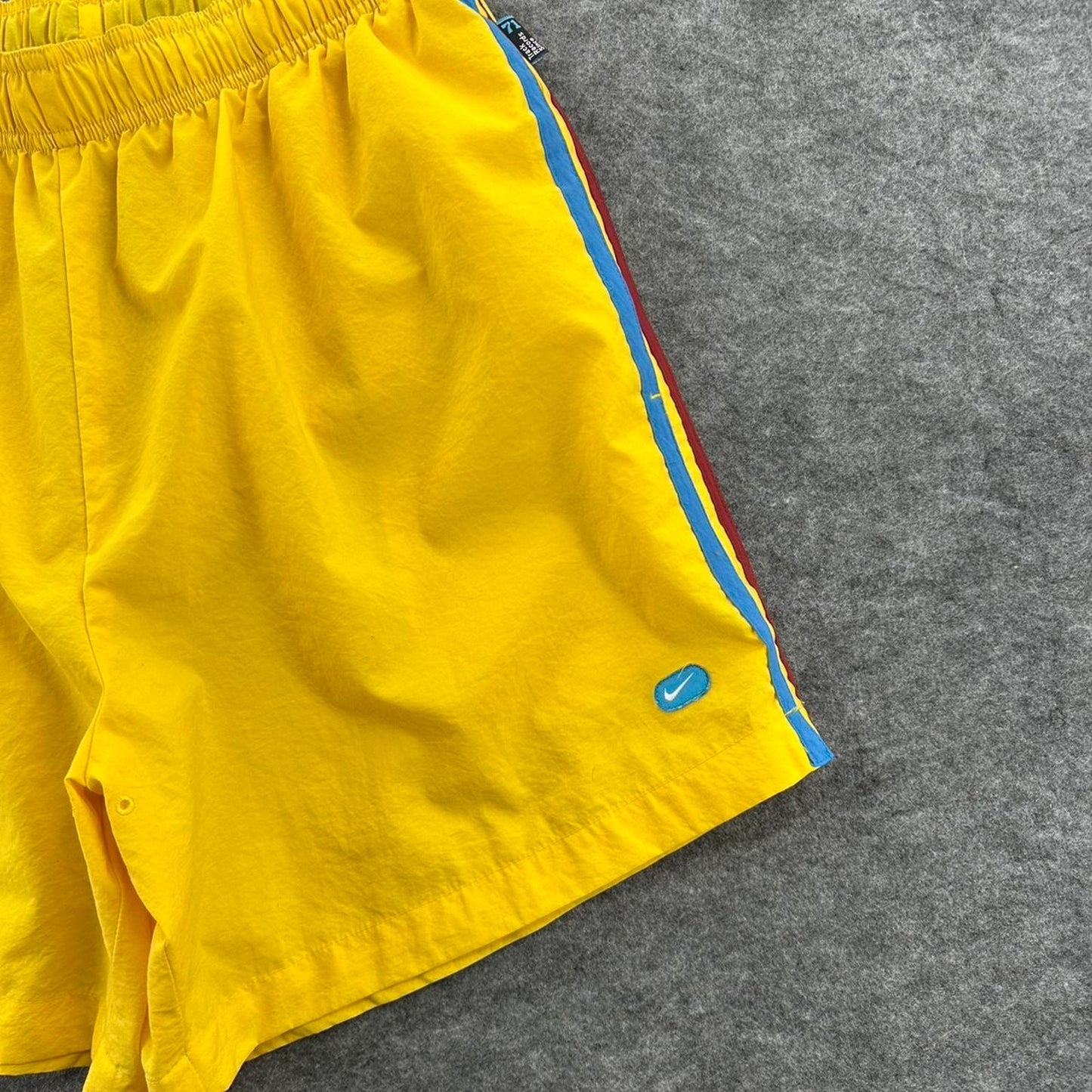 Nike yellow track shorts
