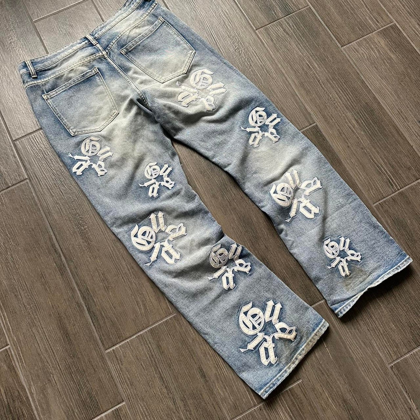 Distressed blue denim jeans with