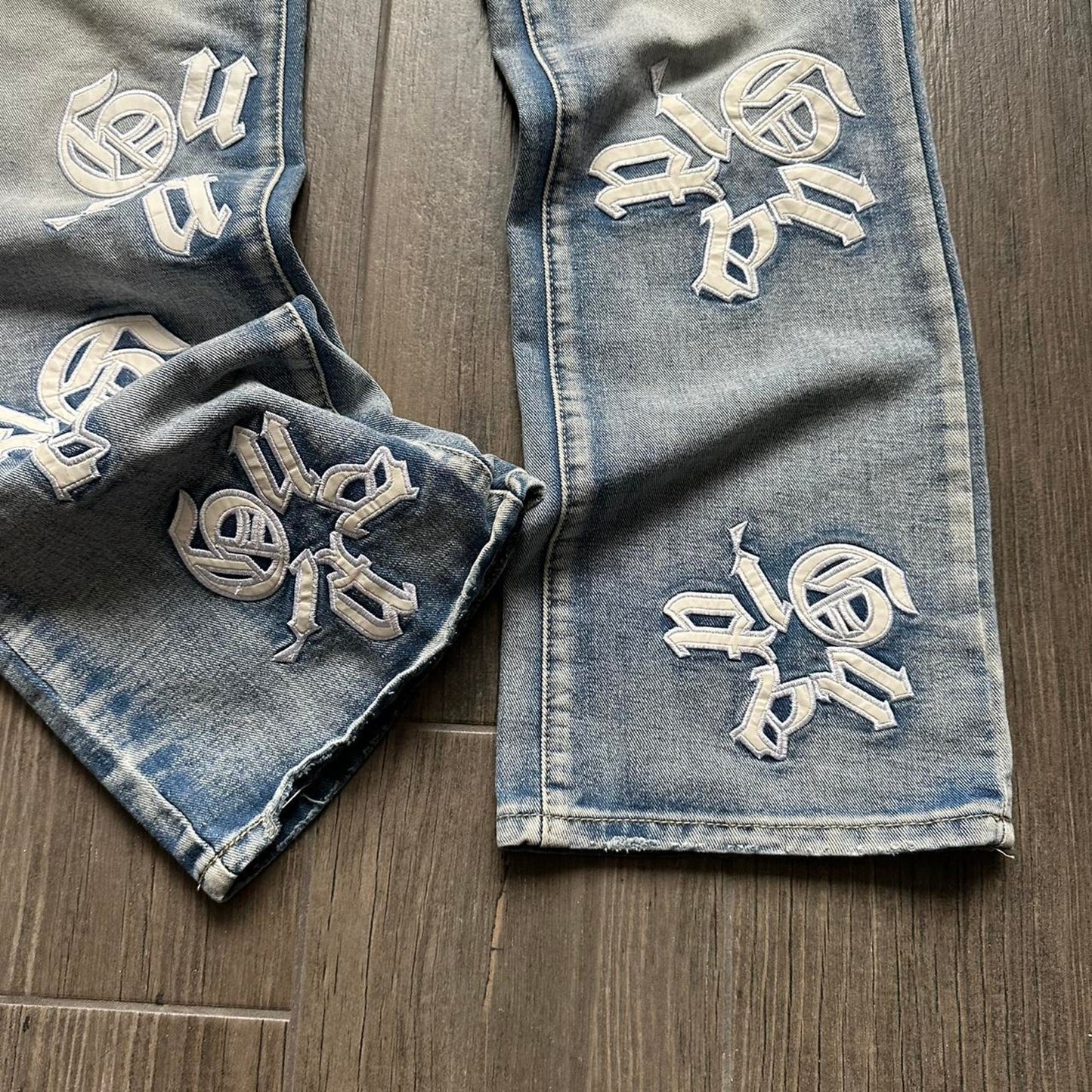 Distressed blue denim jeans with
