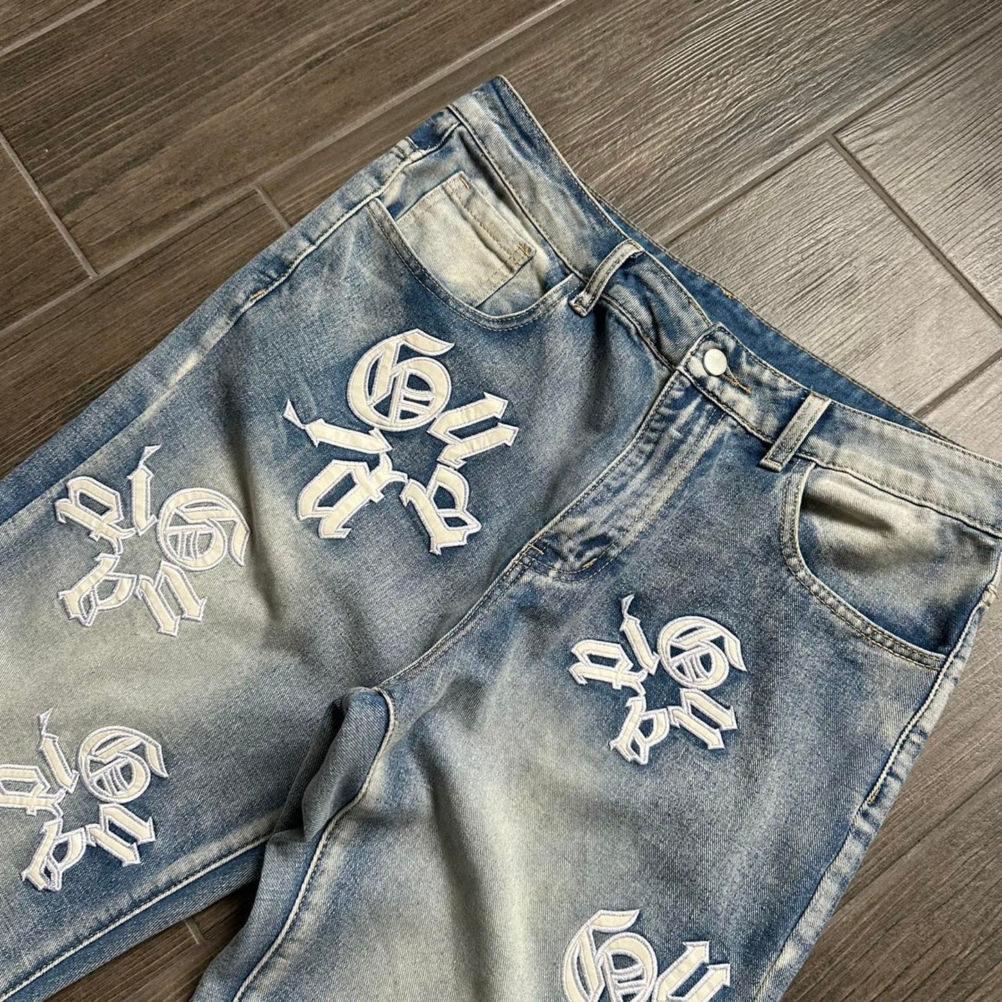Distressed blue denim jeans with