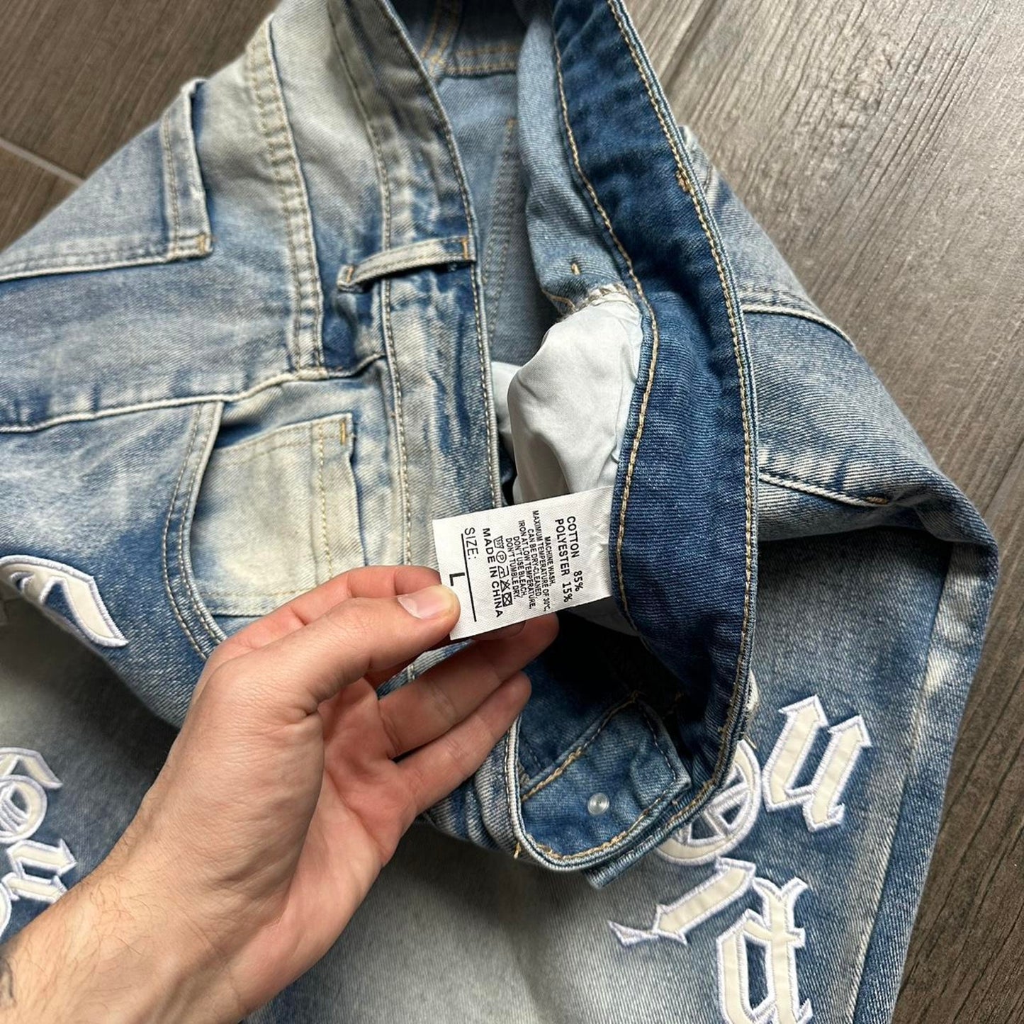 Distressed blue denim jeans with